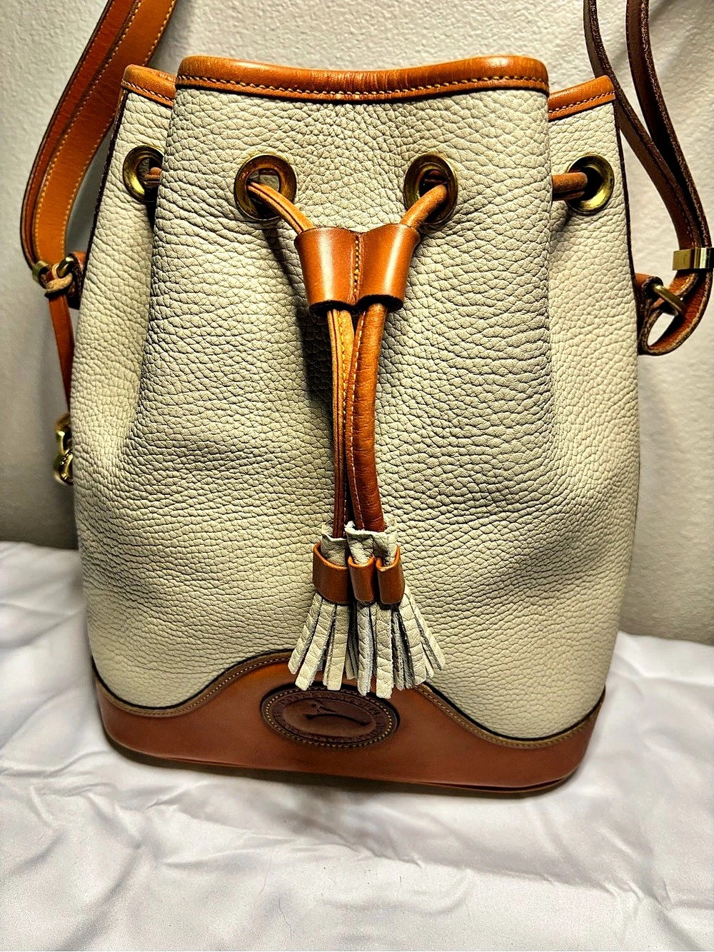 vintage Dooney & Bourke All Weather Leather Bucket Bag in Cream & Brown